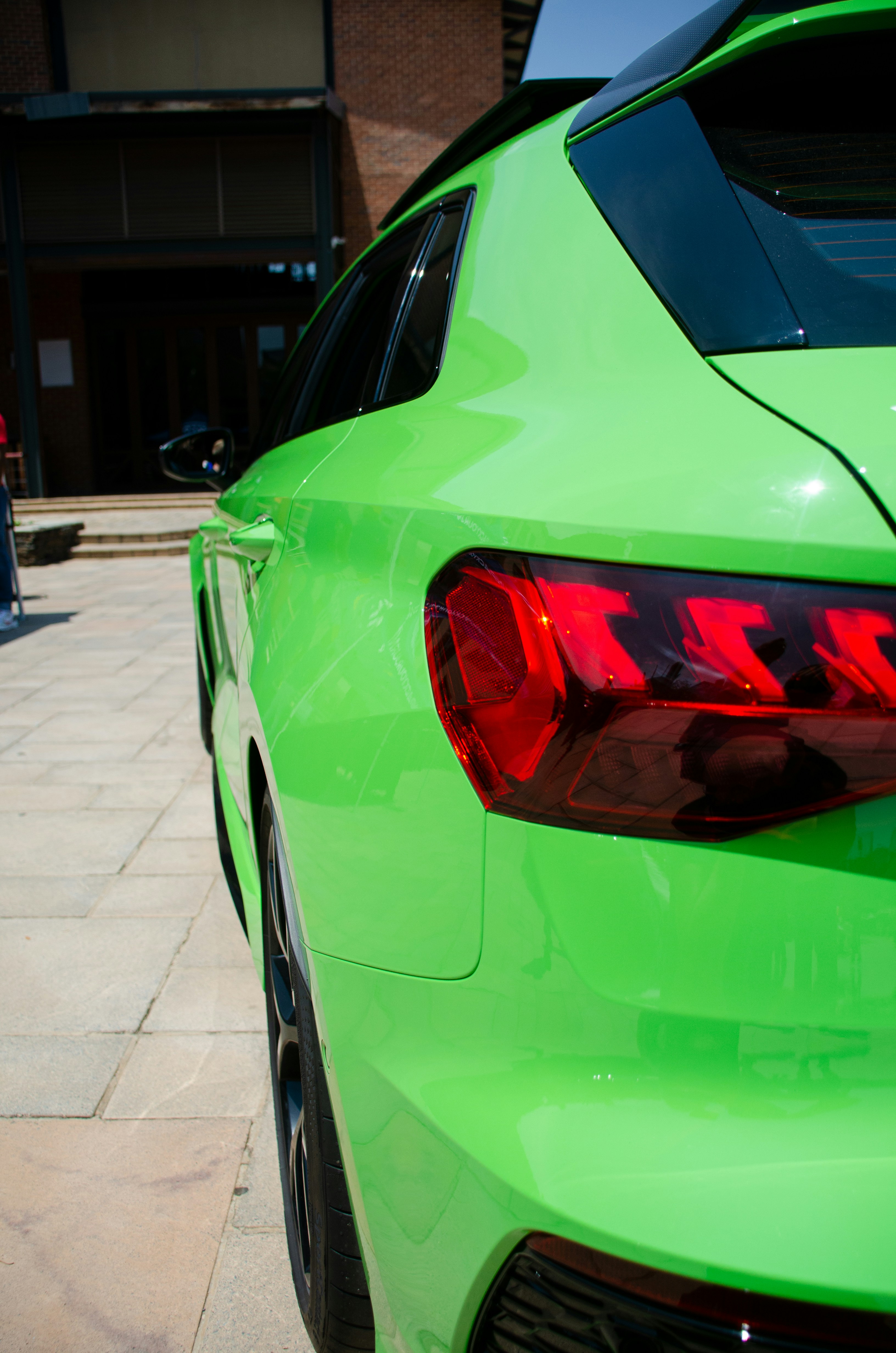 a green car with its lights on
