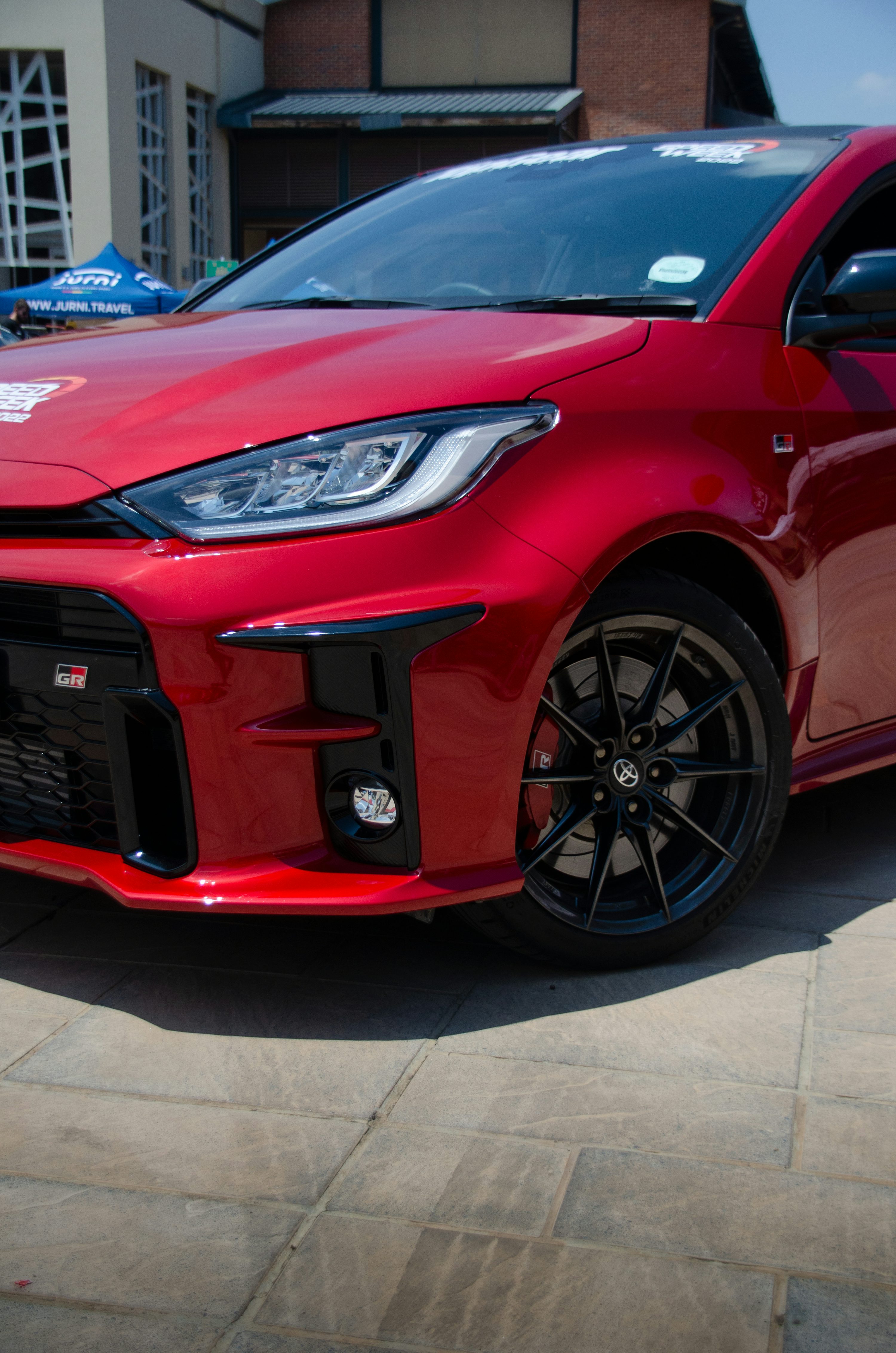 a red car parked in front of a building
