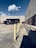 A delivery truck parked in front of a warehouse.