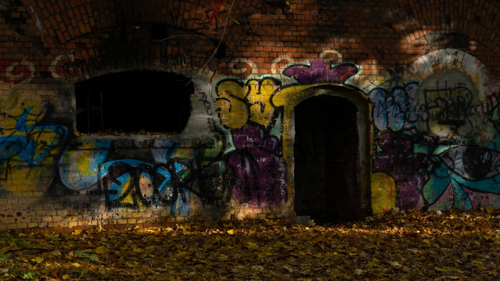 a brick wall with graffiti