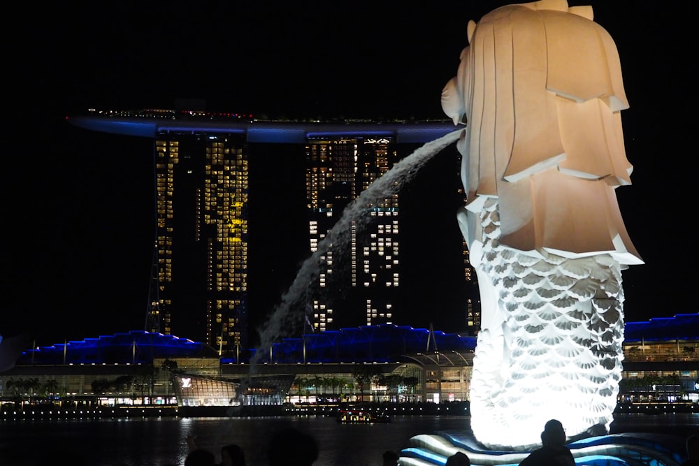 a statue of a person with a city in the background