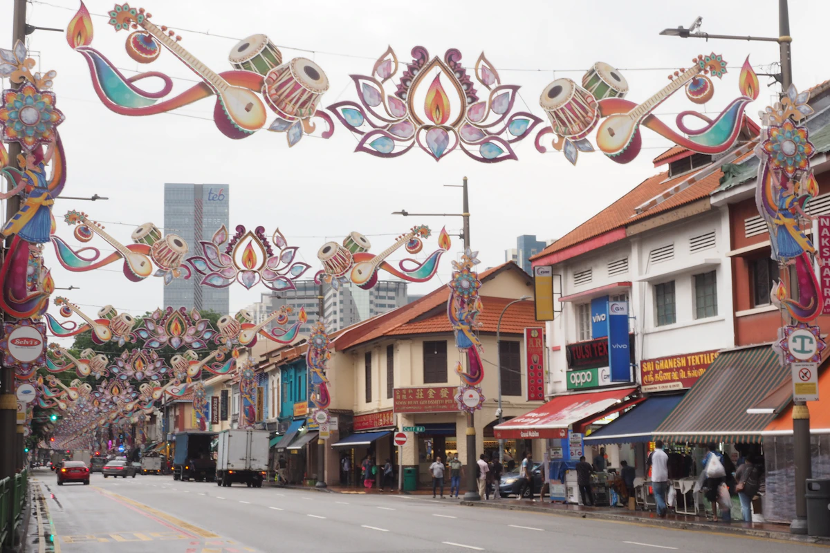 People walking beneath colourful decorations in Singapore's Little India