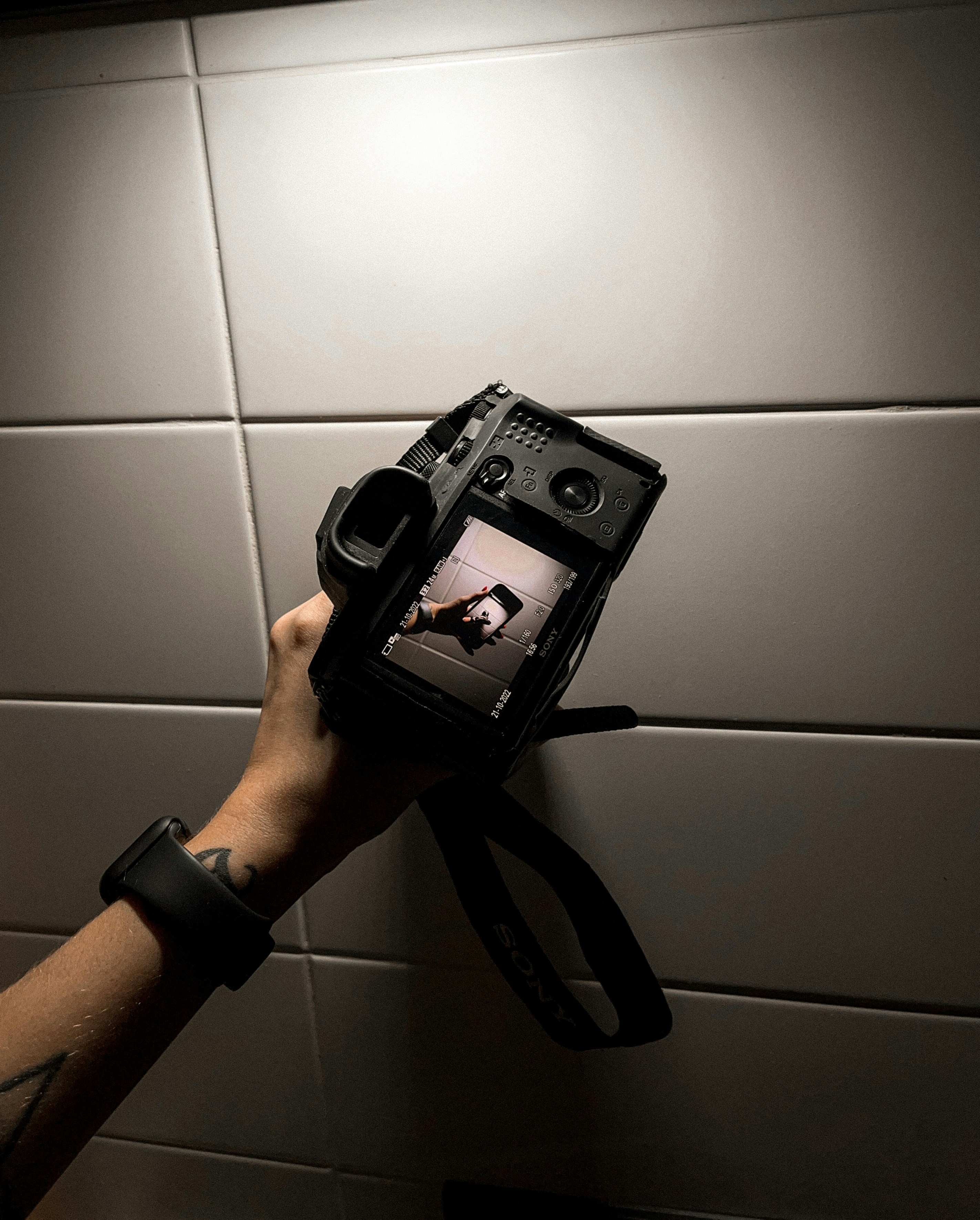 a hand holding a black device