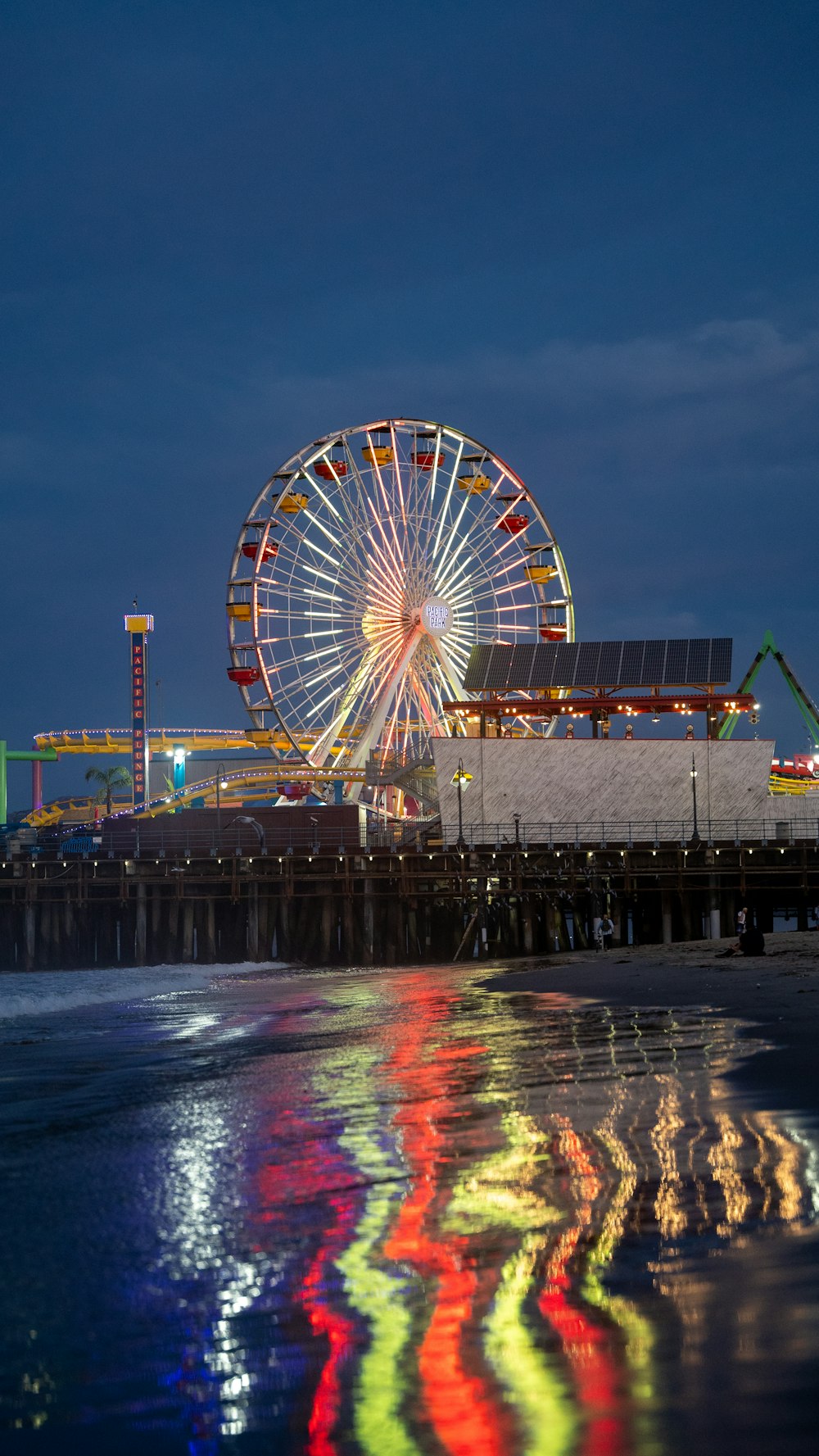 a ferris wheel by a body of water