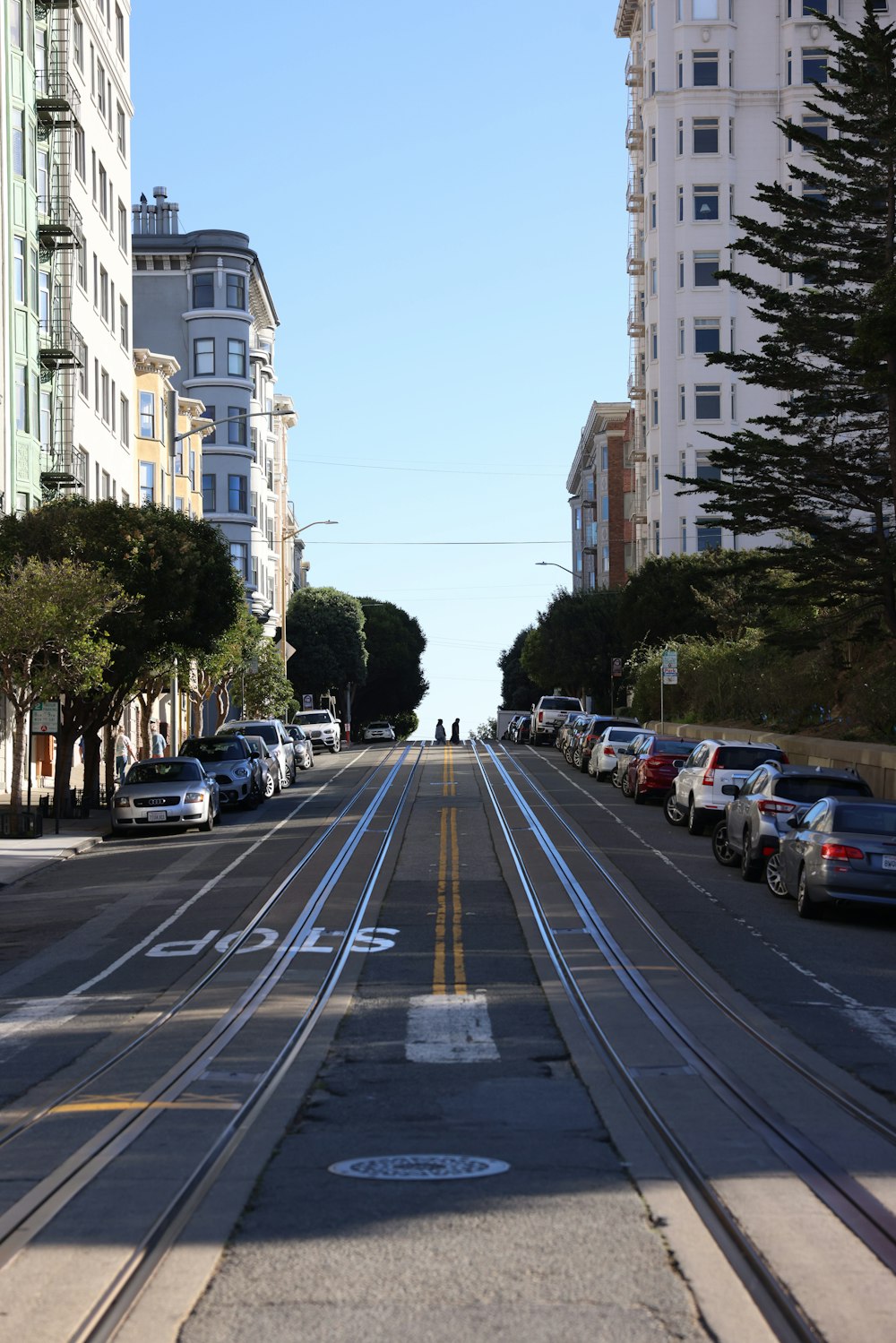 a street with cars on it and buildings on the side