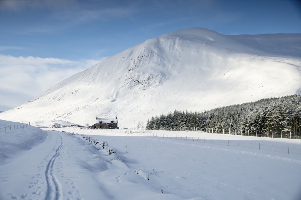 a snowy mountain with a house