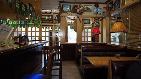 Cozy seafood restaurant interior with rustic wooden tables and fresh fish displays.