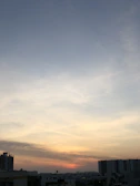 Soft pastel sunset over a calm cityscape, reflecting the serene mood of the blog.