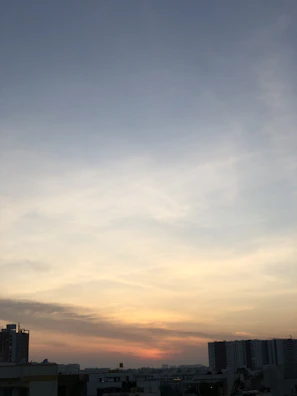 Soft pastel sunset over a calm cityscape, reflecting the serene mood of the blog.