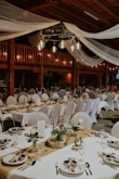 a large room with tables set for a wedding