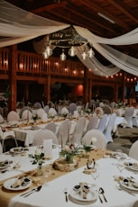 a large room with tables set for a wedding