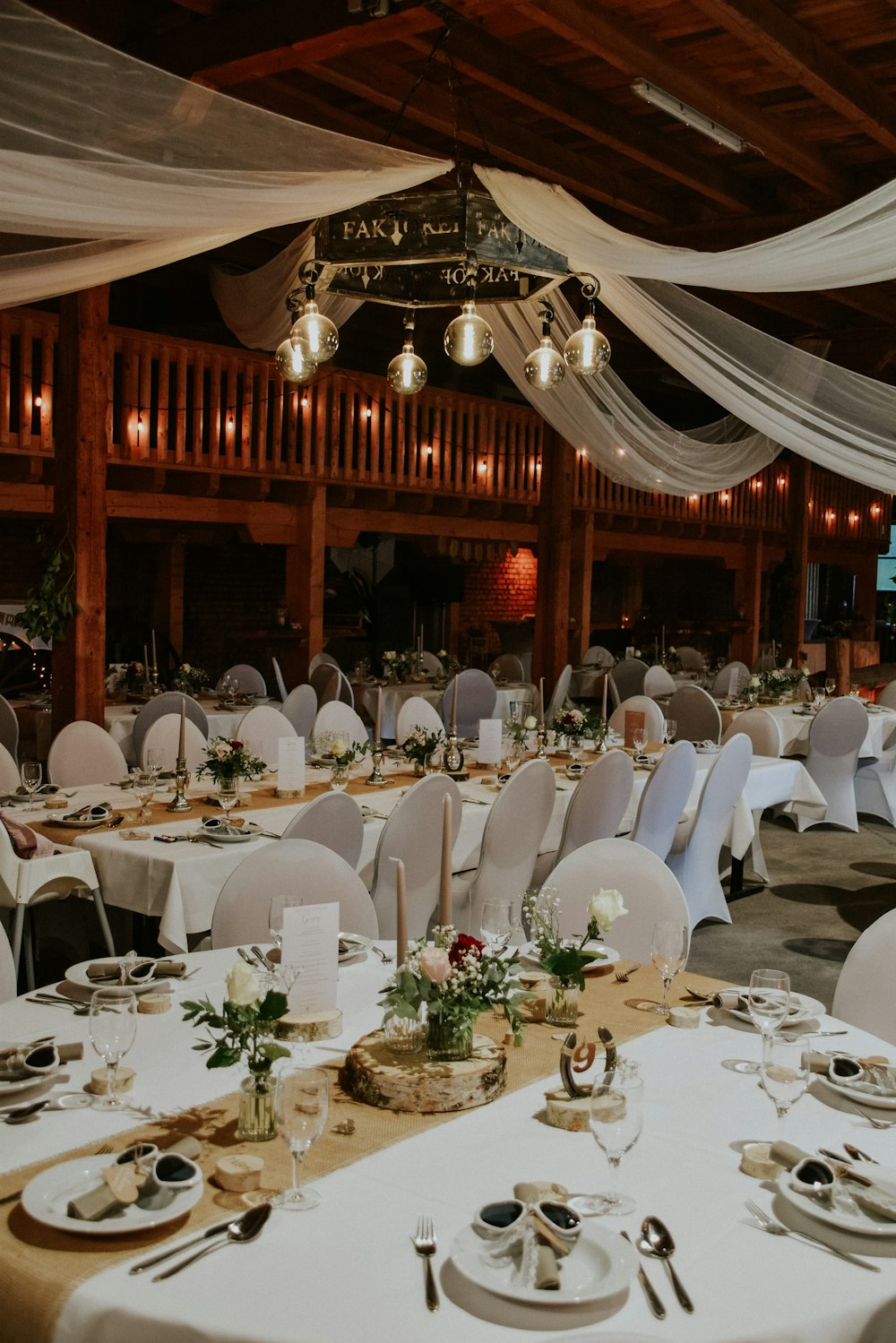 a large room with tables set for a wedding