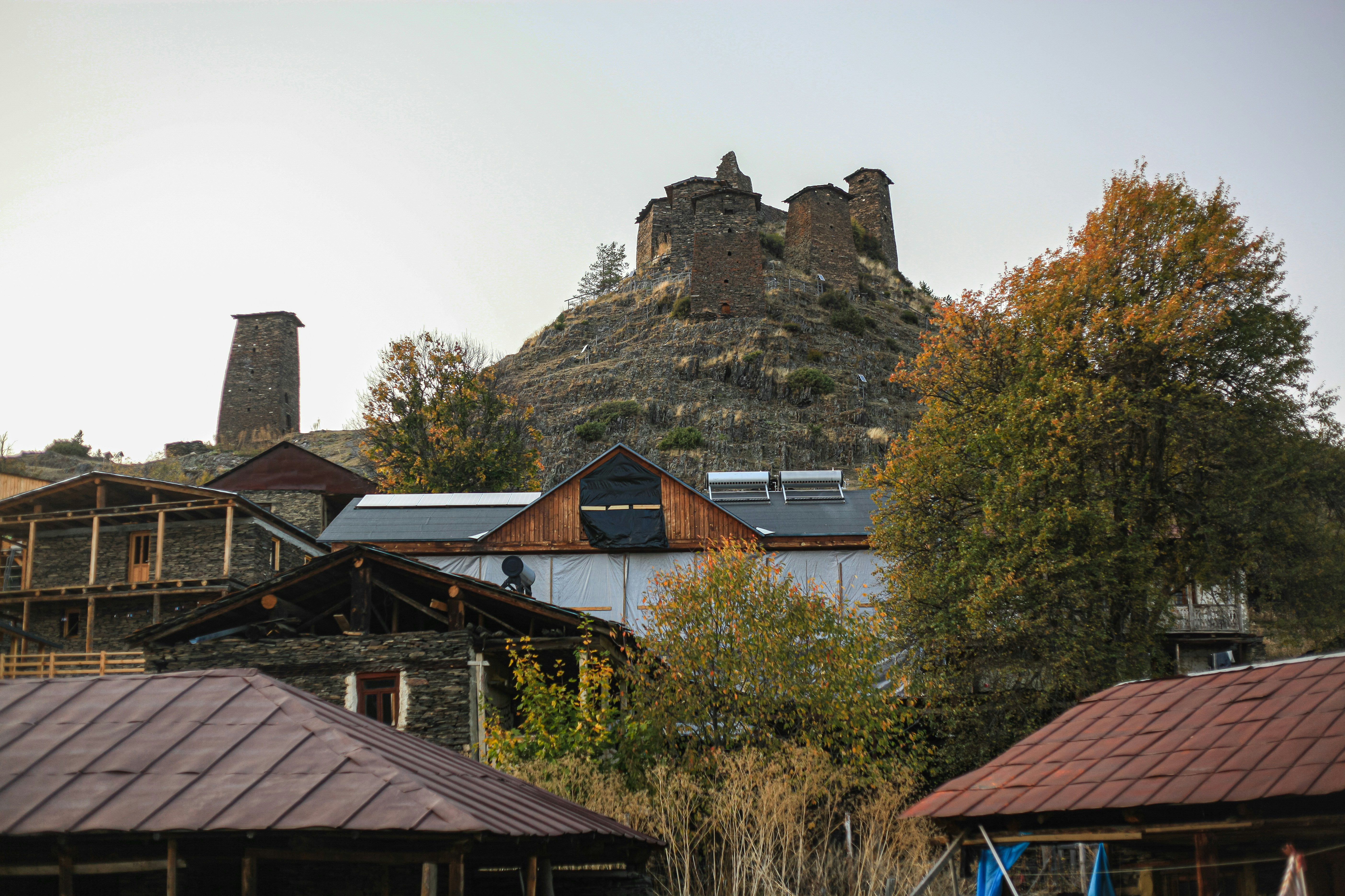 A group of buildings with a large rock on top of them photo – Free ...