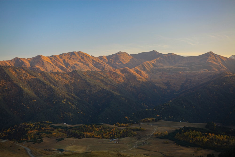 a landscape with mountains in the back