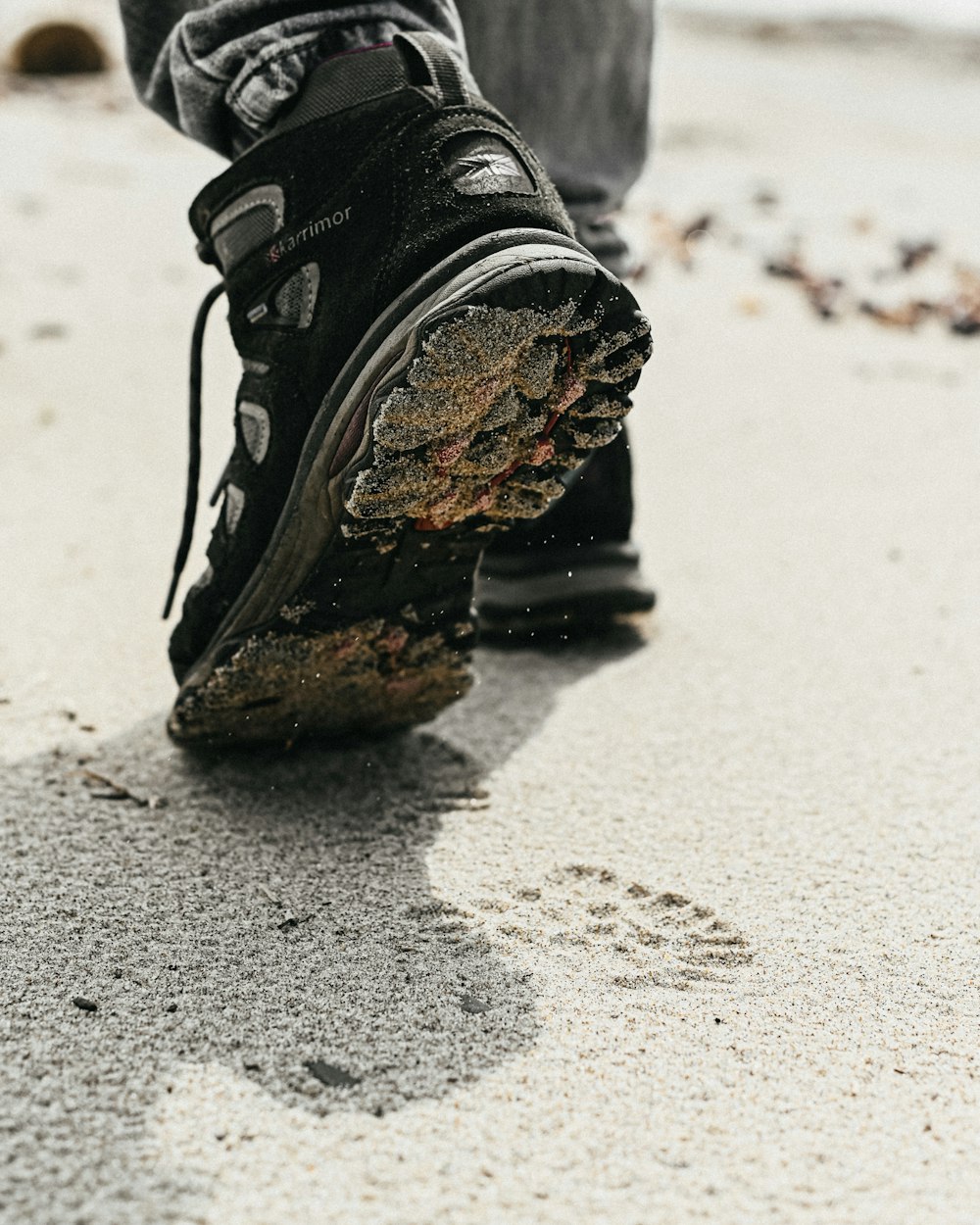 a person's feet in black shoes