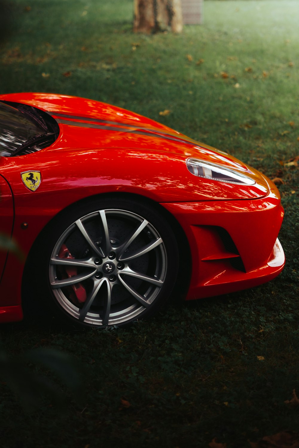 a red sports car parked on grass