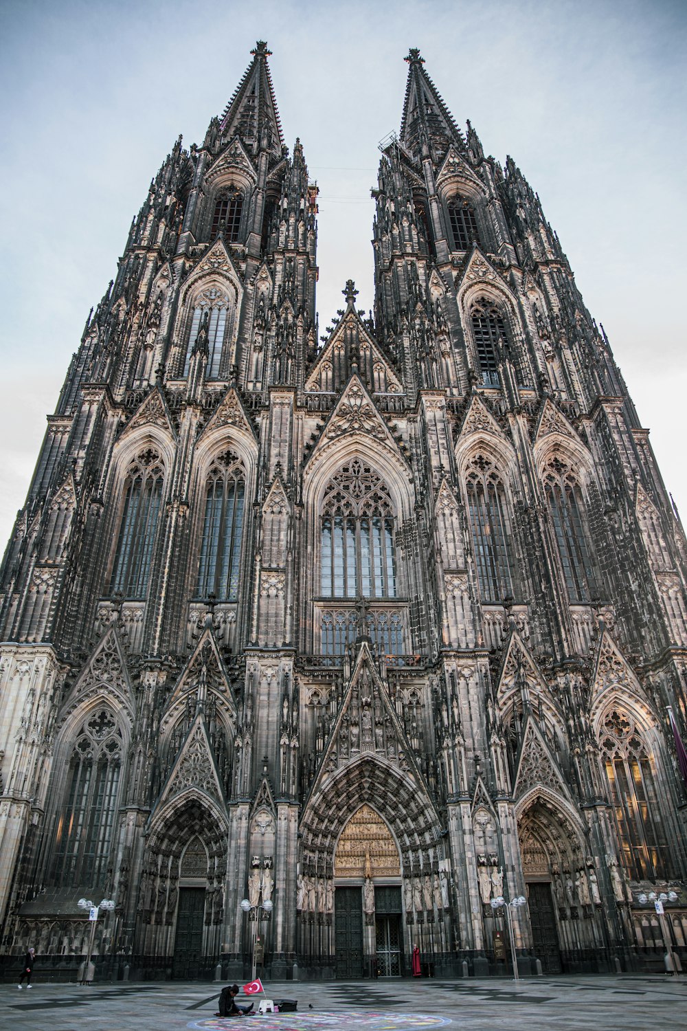 a large stone building with Cologne Cathedral in the background