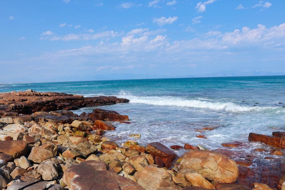 a rocky beach with waves crashing