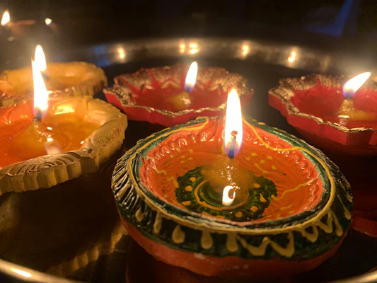 Festive Diwali lamps and intricate patterns illuminated with pops of vibrant color.