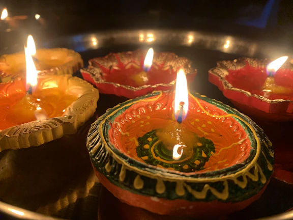 A festive scene with brass diyas illuminating a traditional Indian home during Diwali.