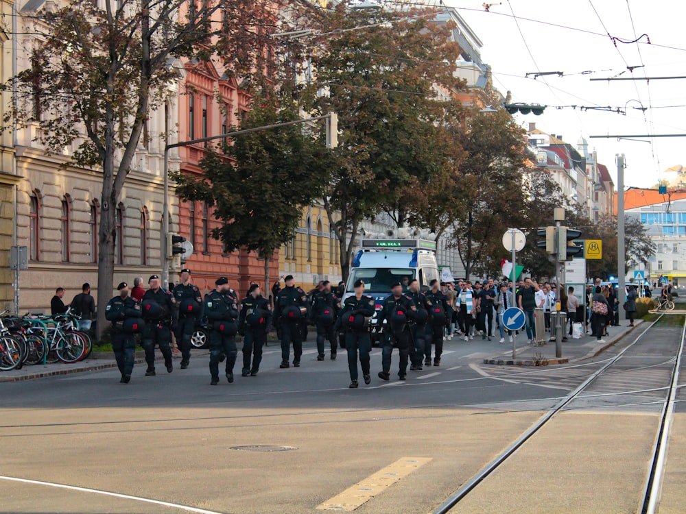 a group of people in uniform marching down a street