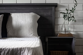 a bed with a vase of flowers