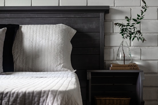 a bed with a vase of flowers