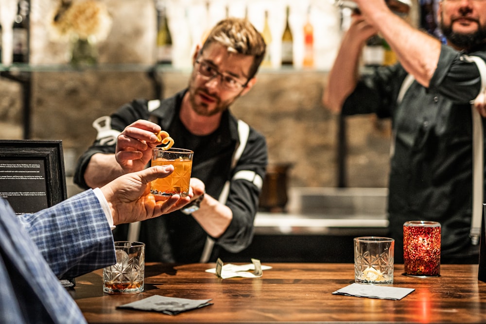 a man holding a glass of beer