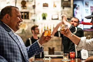 a man holding a glass of beer