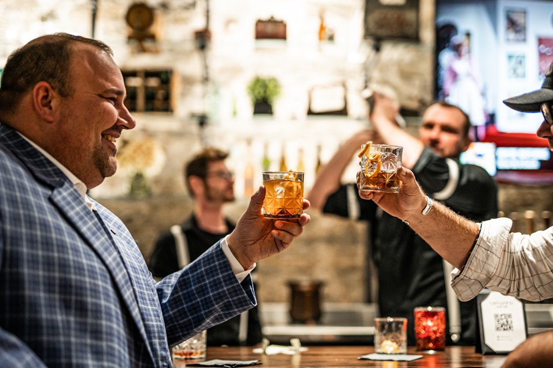 a man holding a glass of beer,