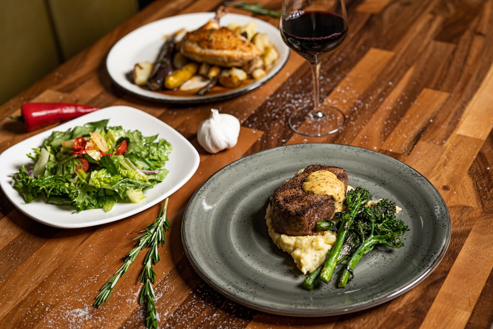 a table with plates of food and wine