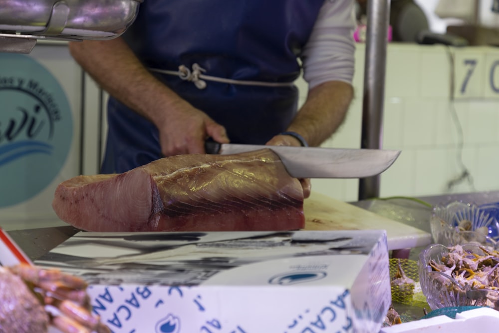 a person cutting meat