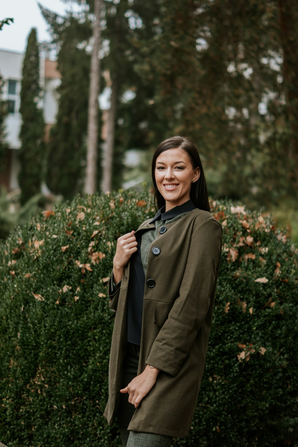 a person standing in front of a bush