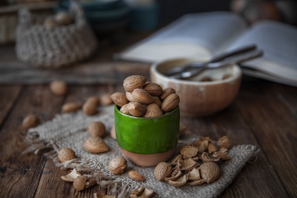 a jar of nuts and a bowl of nuts on a table