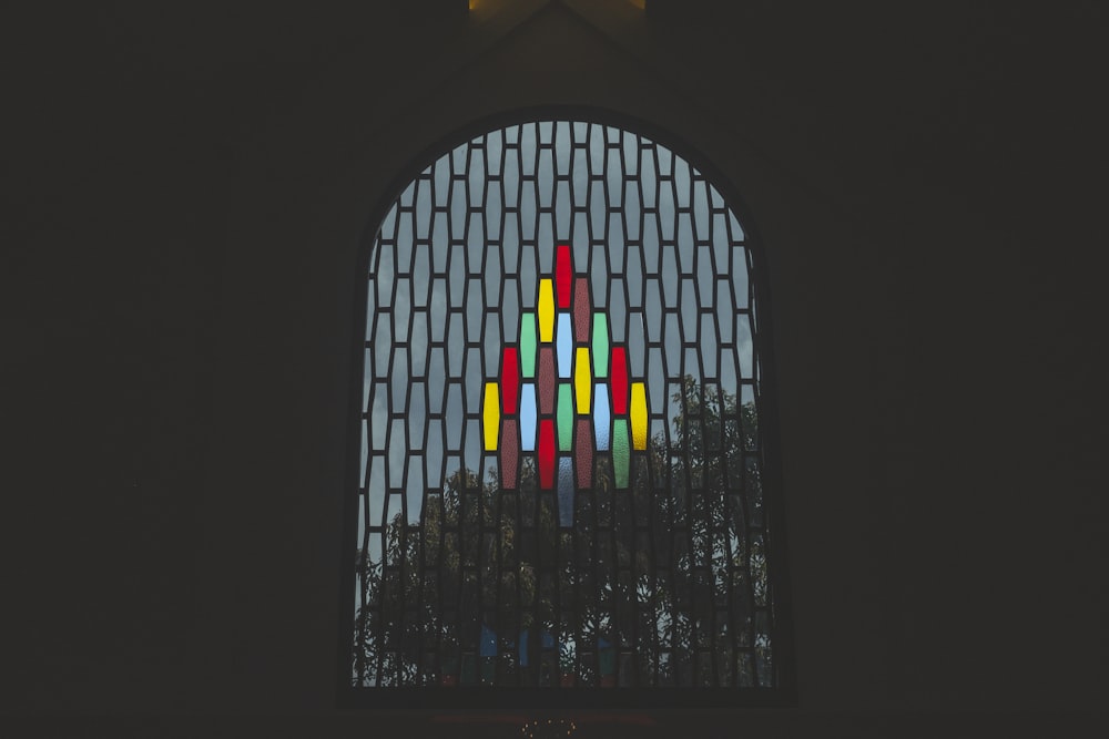 a group of colorful candles in a window