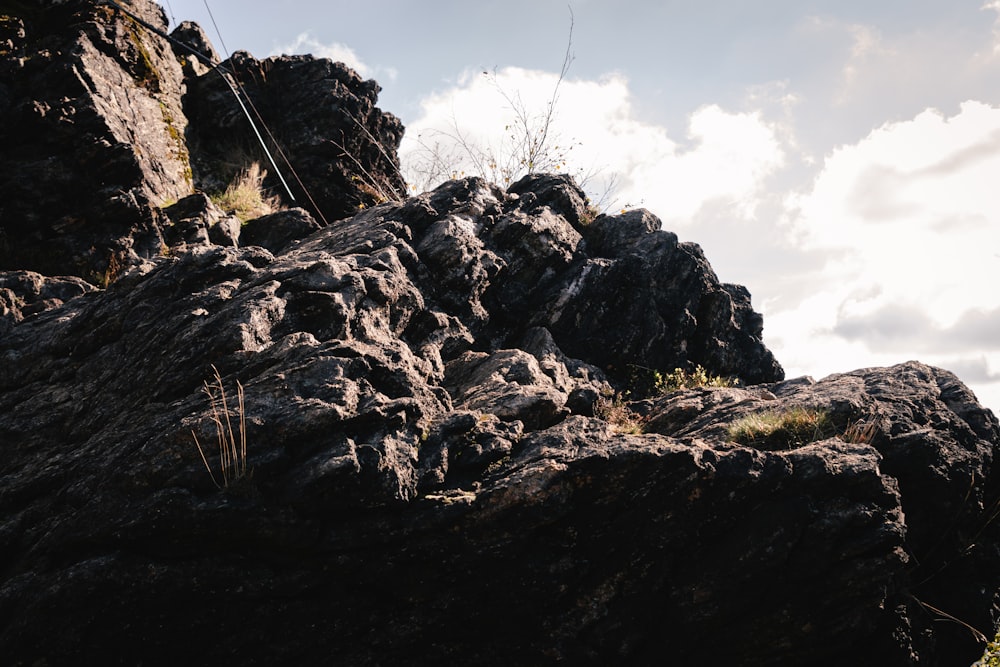 a rocky mountain with a wire fence