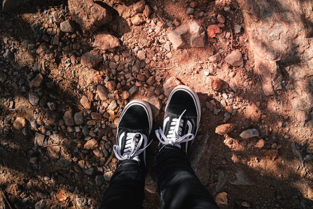 a person's feet on a rocky surface