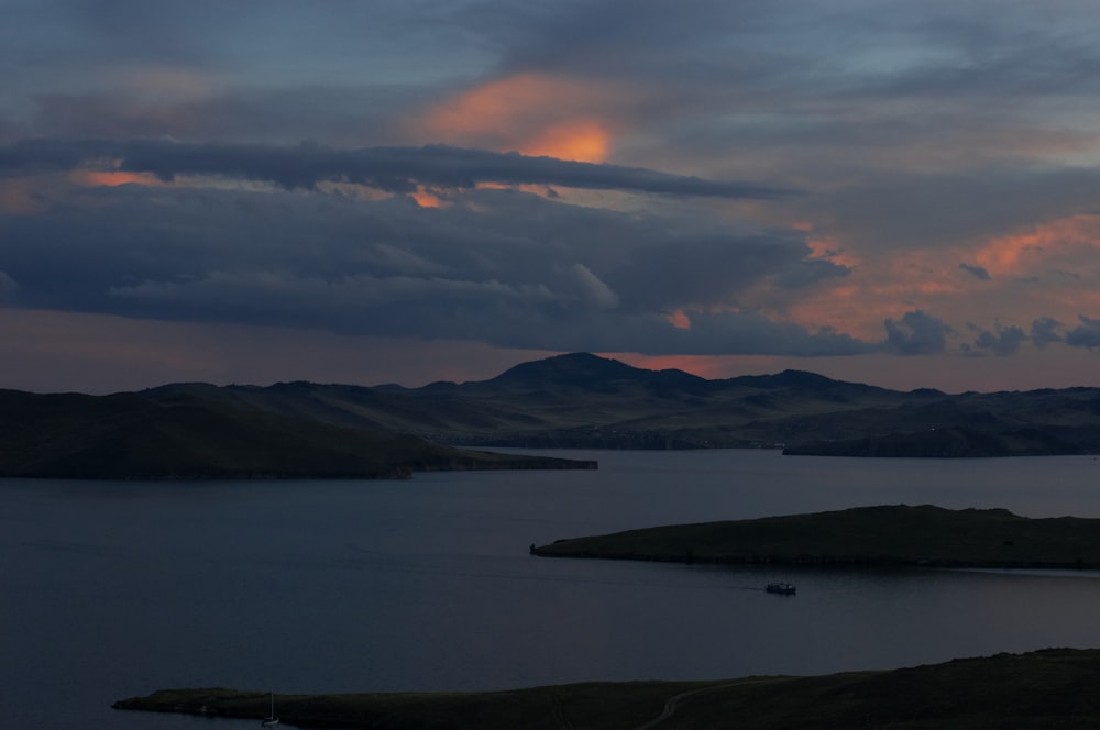 a body of water with land in the back