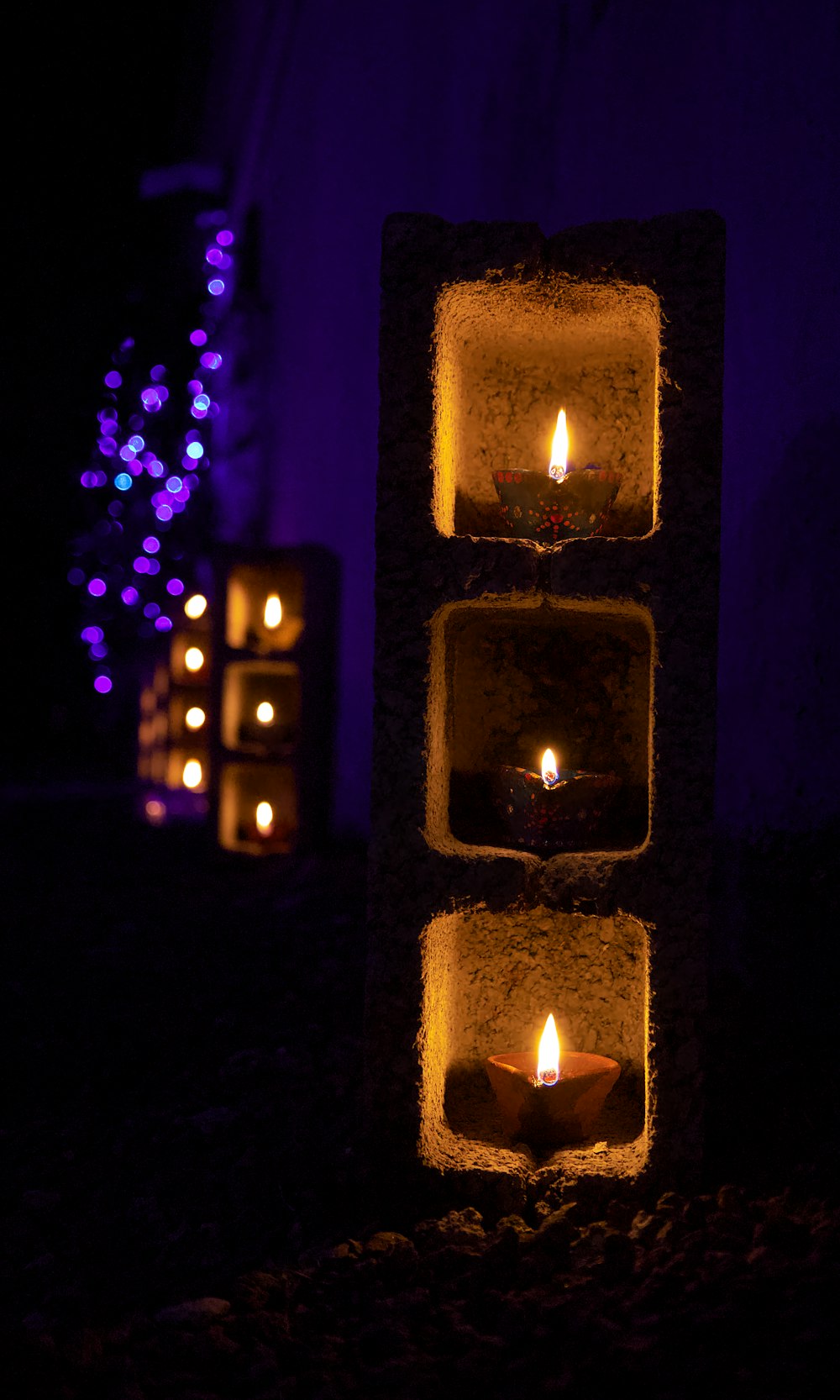 a group of candles in a dark room