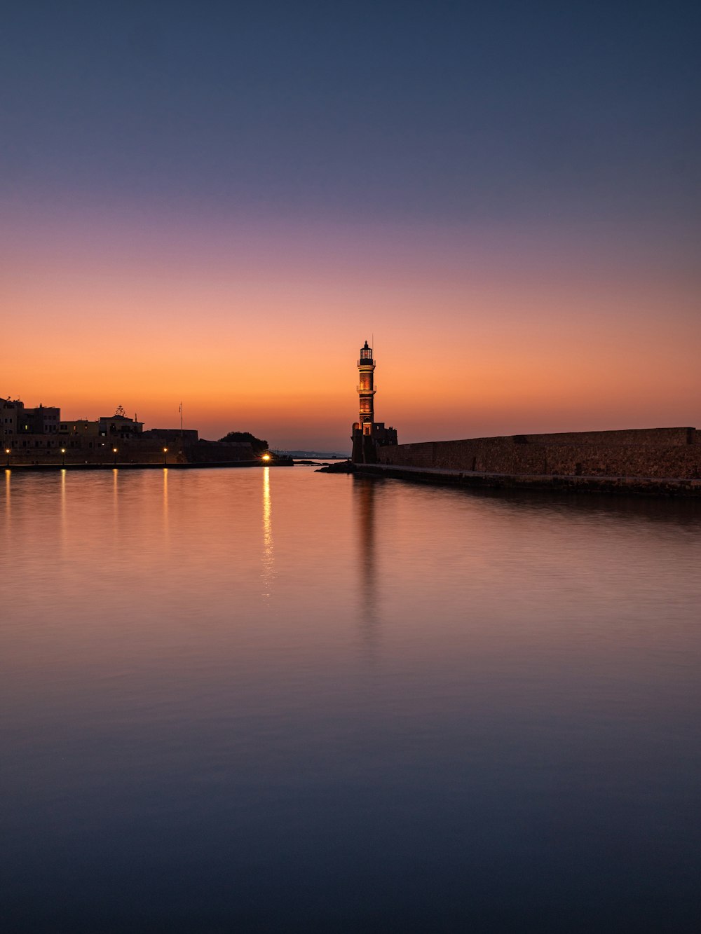 a body of water with a tower in the distance