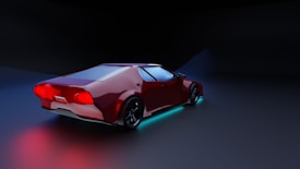 A sleek red sports car is displayed against a dark background. It features glowing neon lights underneath, creating an illuminated effect on the ground. The car's design is modern and aerodynamic, with shiny black wheels and distinctive rear lights.