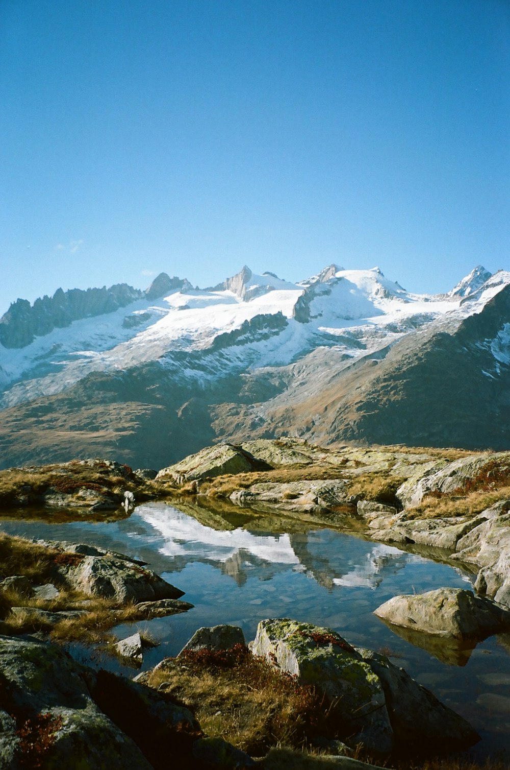 a body of water with mountains in the background