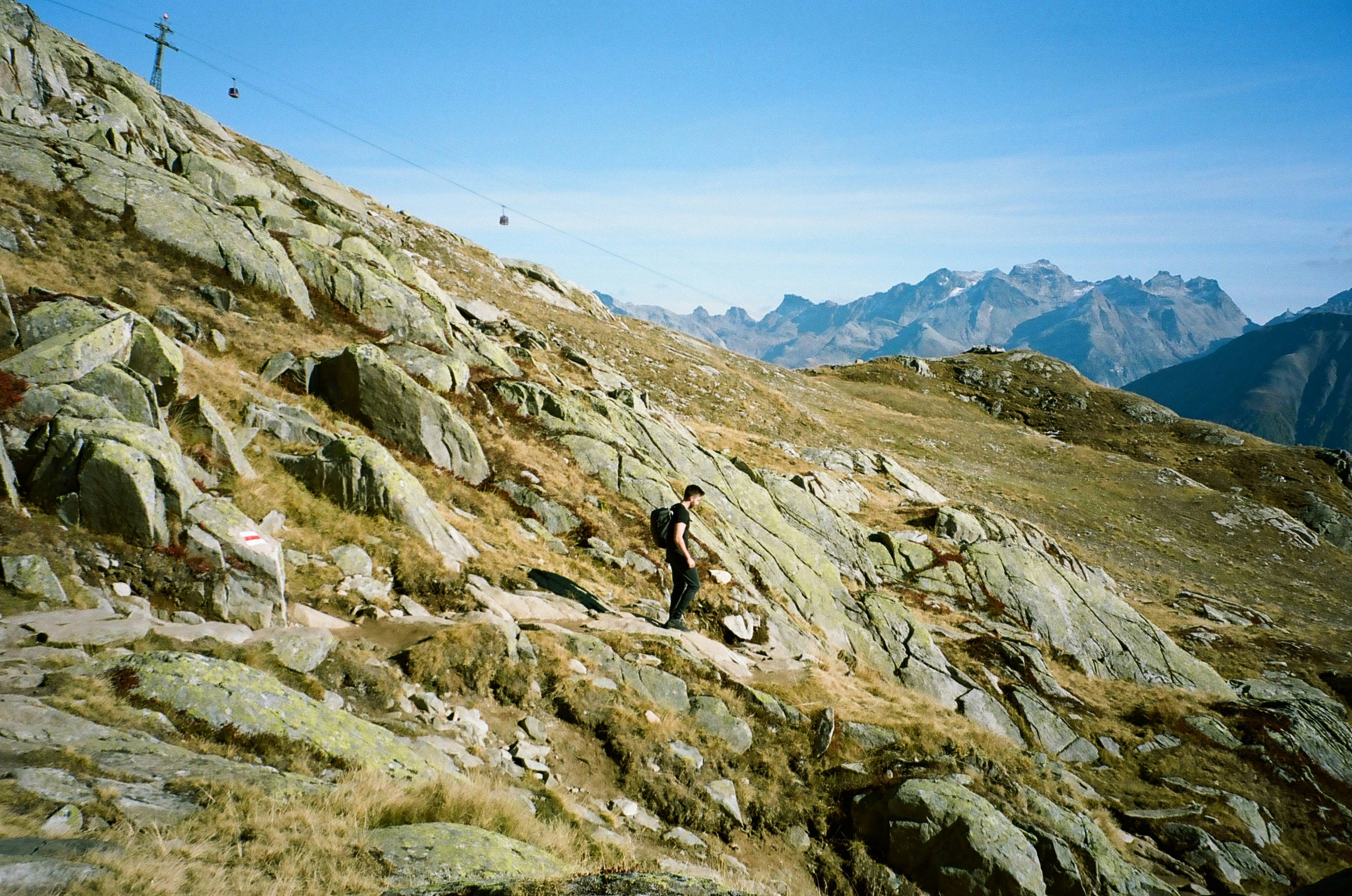 a person walking on a rocky hill