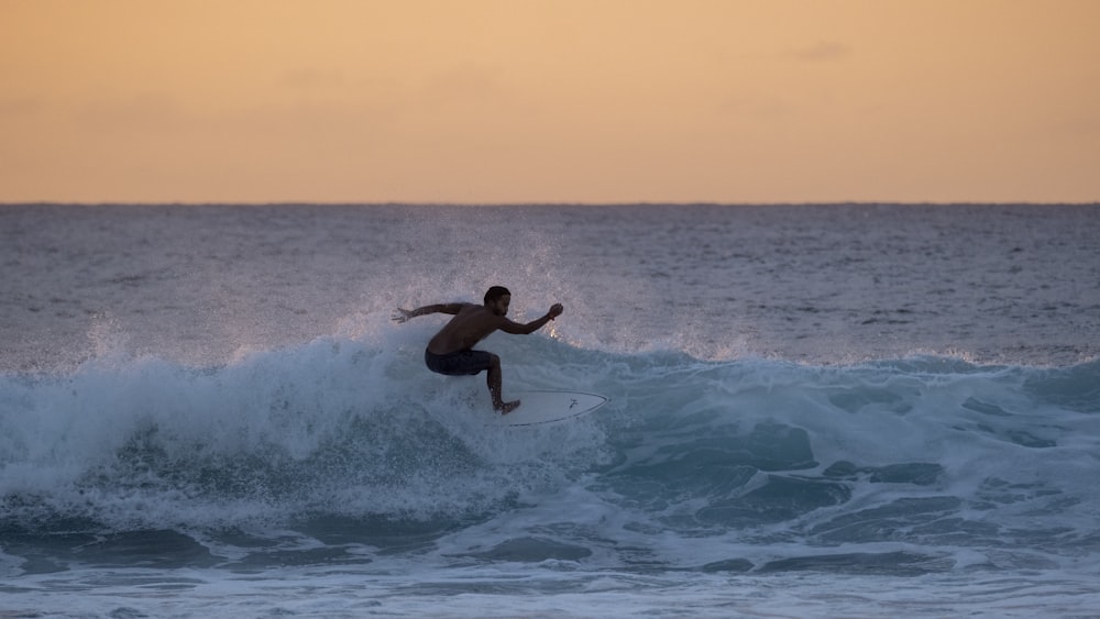 a man surfing on the waves