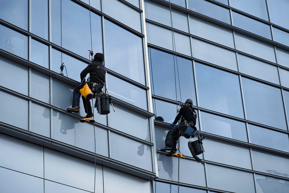 a few men climbing a building