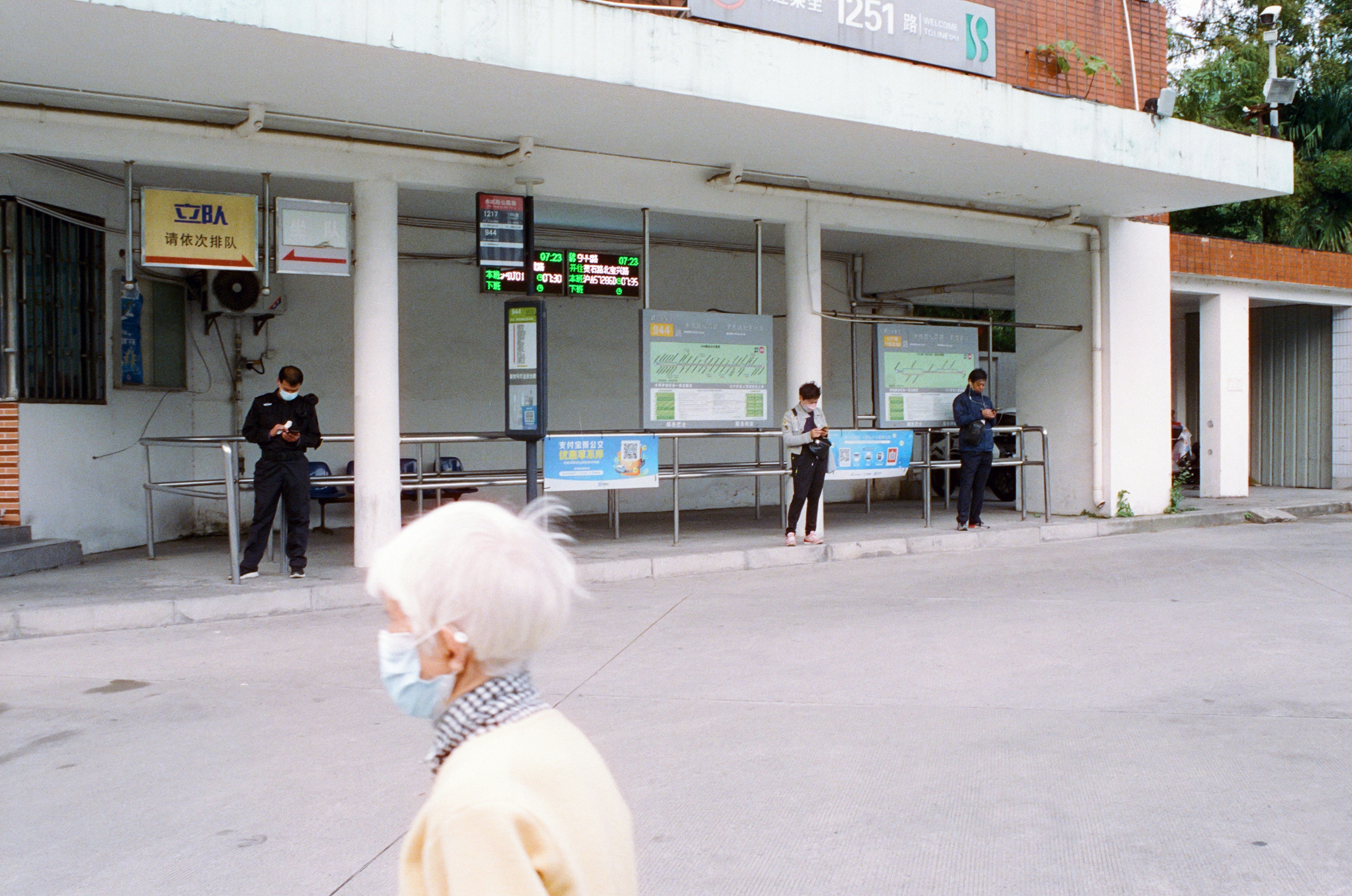 EV driver checking a charging station location on a smartphone next to a charging car