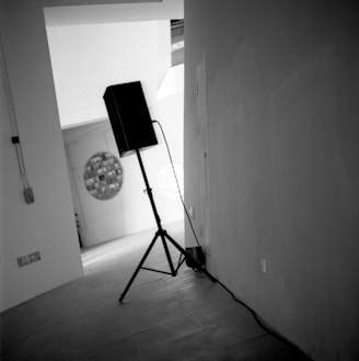 Close-up of a sleek modern PA sound system speaker in a cozy event space