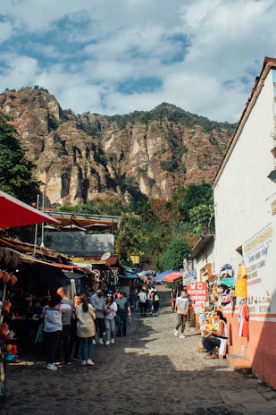 A vibrant street market in a colorful Latin American town bustling with locals and tourists.