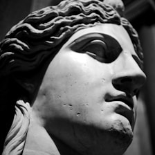 A close-up of intricate details on a marble statue, showcasing fine craftsmanship.