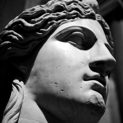 Close-up of a marble sculpture showing a child's joyful expression in soft natural light.